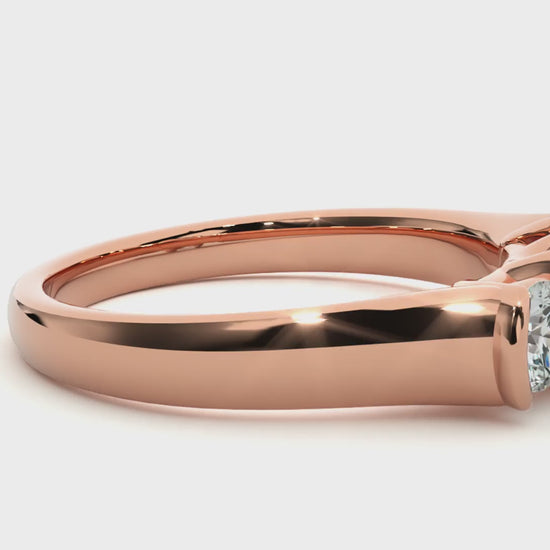 Three-stone engagement ring with bar-set diamonds in rose gold